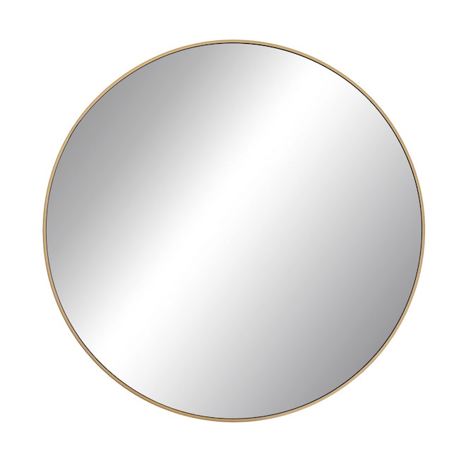 Round mirror with a brass frame