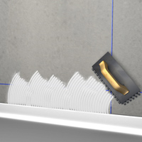 Spreading the adhesive for the first row of tiles