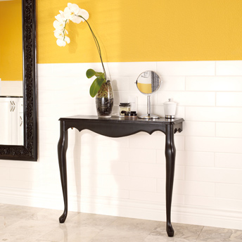 Bathroom half-wall covered with white ceramic tiles.
