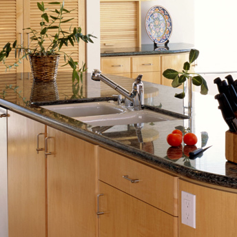 Undermount white kitchen sink in a granite or stone countertop
