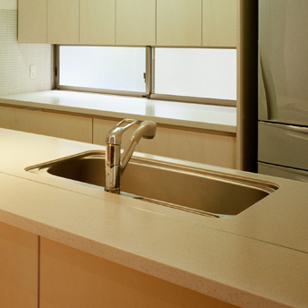 Large kitchen sink under solid-surface countertop