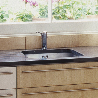 Single-bowl kitchen sink under solid-surface countertop