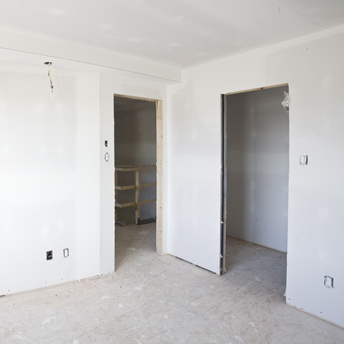 Drywall is hung on wall and ceiling studs. 