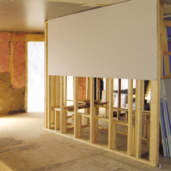 Drywall is hung on wall studs. 