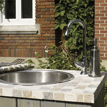 Outdoor cooking station with sink and a pergola
