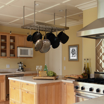 A pot rack above the work area and close to the cooking area